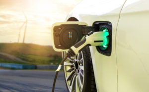 Electric,Car,Or,Ev,Car,Charging,In,Station,On,Blurred